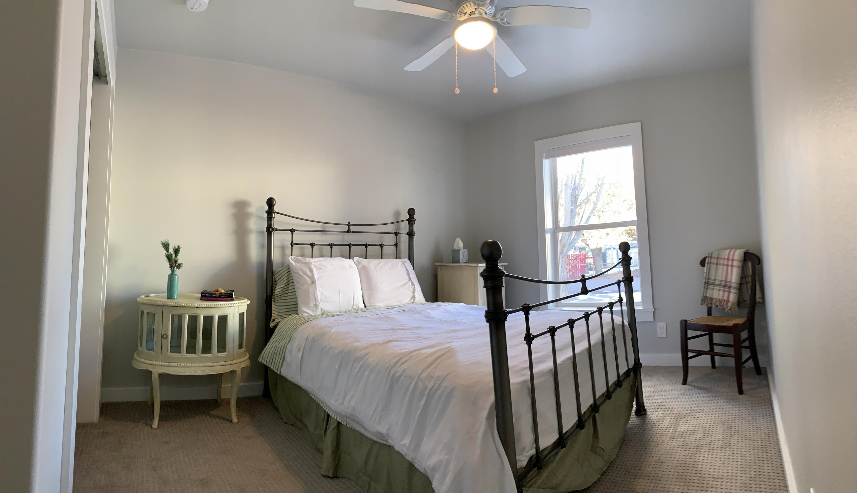 837 Alpine Road Montrose, CO 81403 - Photo 11 of 16 a bedroom with a bed and a chandelier