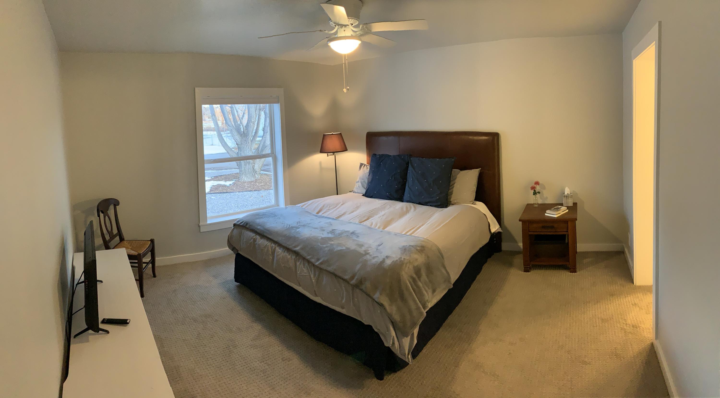 837 Alpine Road Montrose, CO 81403 - Photo 7 of 16 a bedroom with a bed and a chandelier