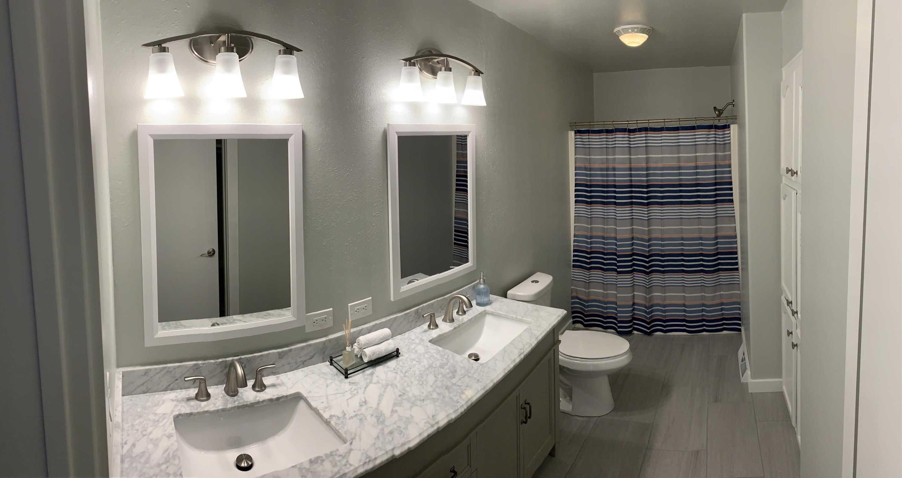 837 Alpine Road Montrose, CO 81403 - Photo 8 of 16 a bathroom with a sink double vanity and a mirror