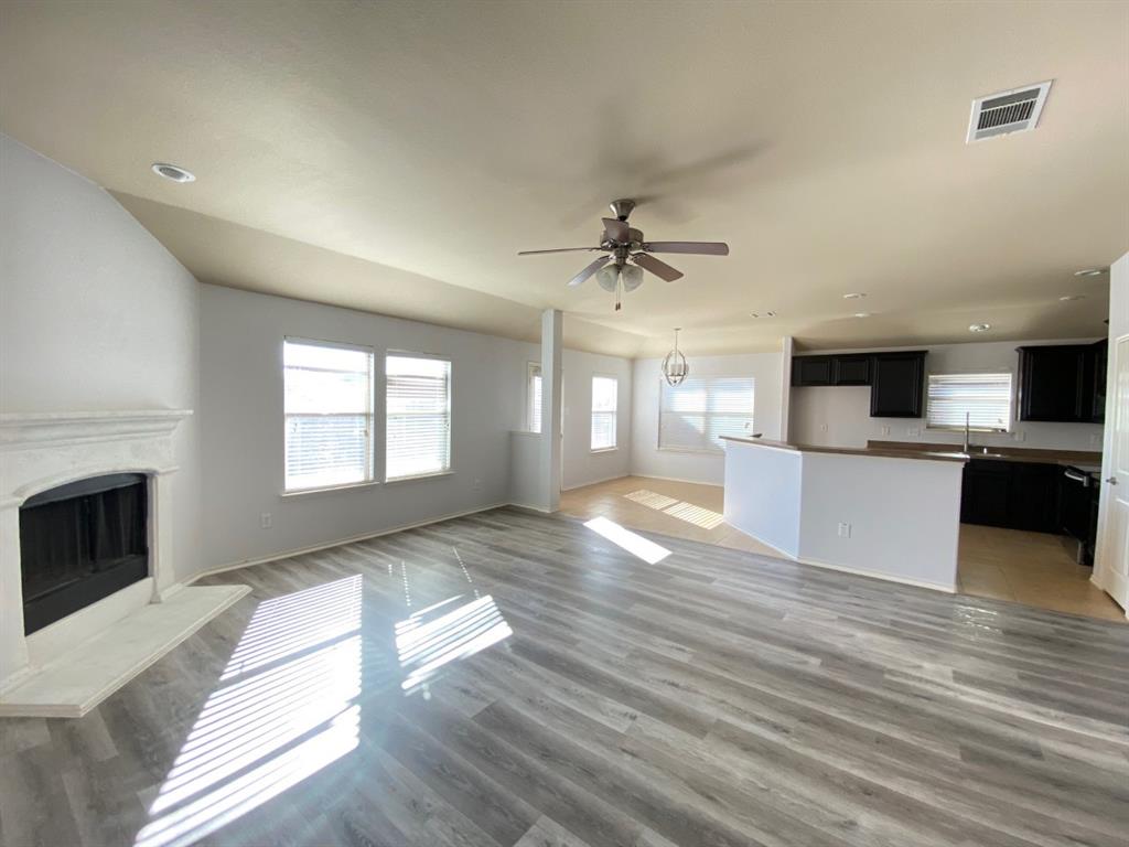 148 Meadow Crest Drive Princeton, TX 75407 - Photo 1 of 18 a view of a kitchen with a sink dishwasher and a fireplace