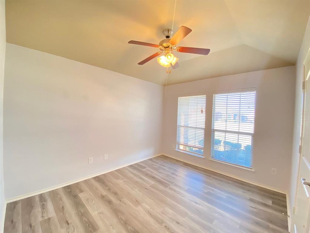 148 Meadow Crest Drive Princeton, TX 75407 - Photo 12 of 18 an empty room with wooden floor fan and windows