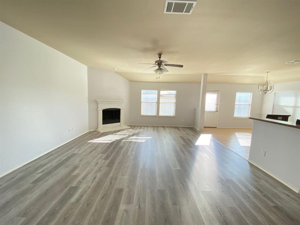 148 Meadow Crest Drive Princeton, TX 75407 - Photo 4 of 18 an empty room with wooden floor and windows