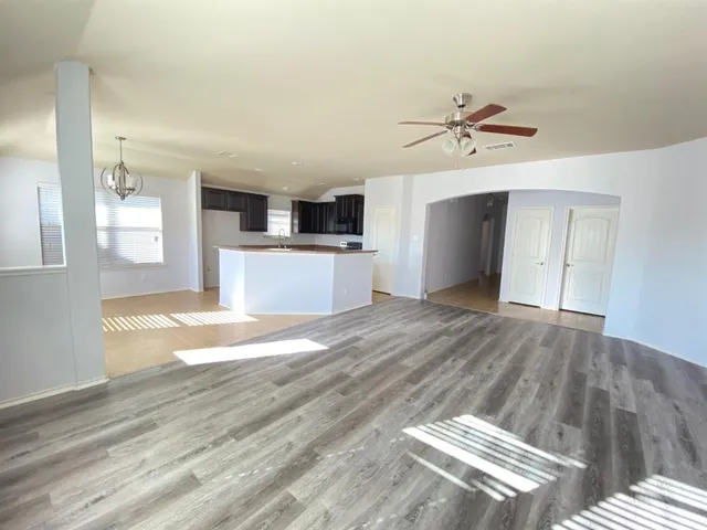 a view of kitchen and hall with wooden floor