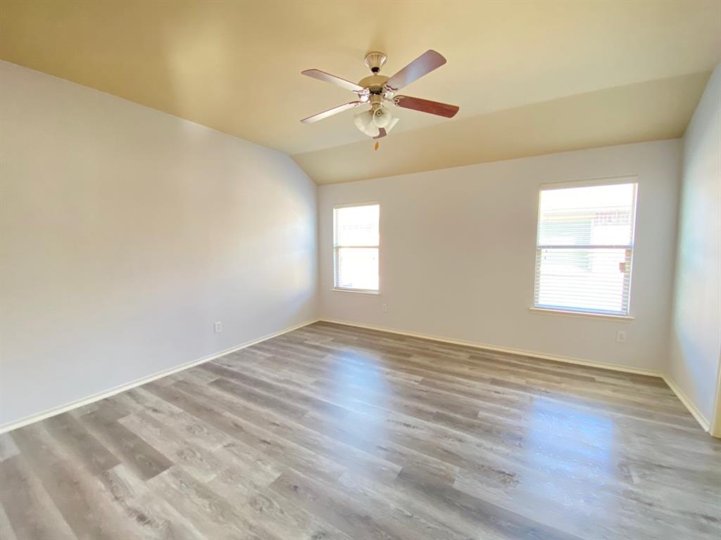 148 Meadow Crest Drive Princeton, TX 75407 - Photo 9 of 18 wooden floor in an empty room with a window