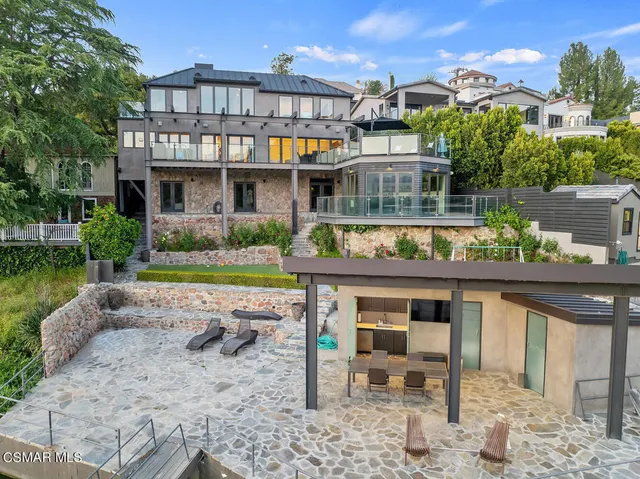 a living room with furniture and view of kitchen