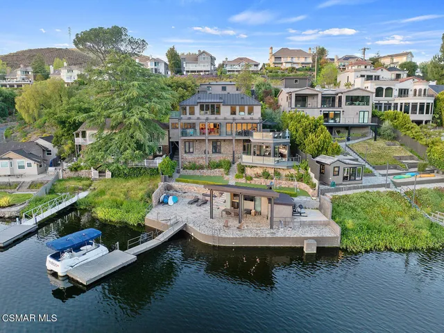 a living room with furniture a large window and a flat screen tv