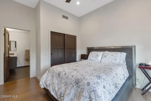 a bedroom with furniture and a flat screen tv