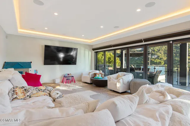 a living room with couch and large windows