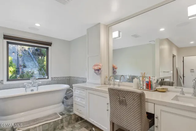 a view of a house with a yard and a large tree