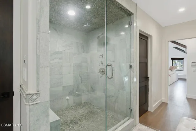 a view of a house with a yard and a large tree