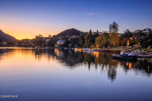 a terrace with outdoor seating and lake view