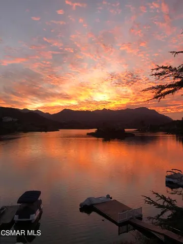 a view of residential houses with outdoor space and lake view