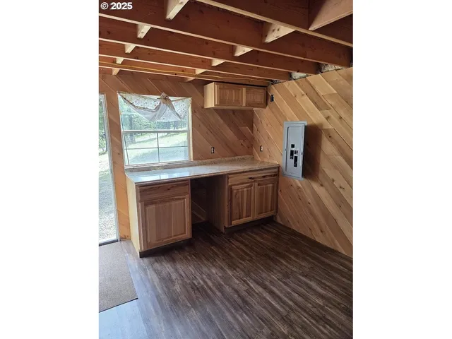 a kitchen with granite countertop a sink and cabinets