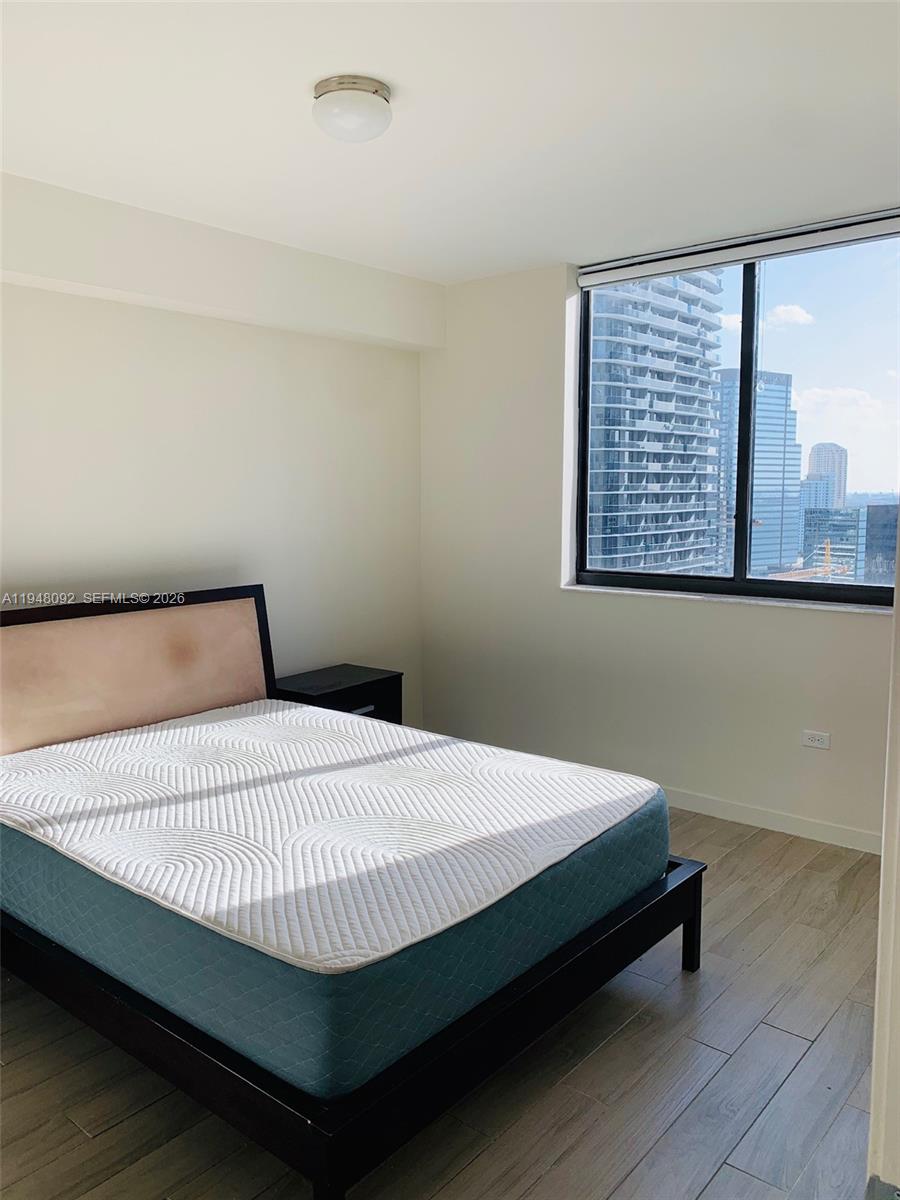 999 Southwest 1st Avenue, Unit 2310 Miami, FL 33130 - Photo 11 of 17 a bedroom with a bed and window