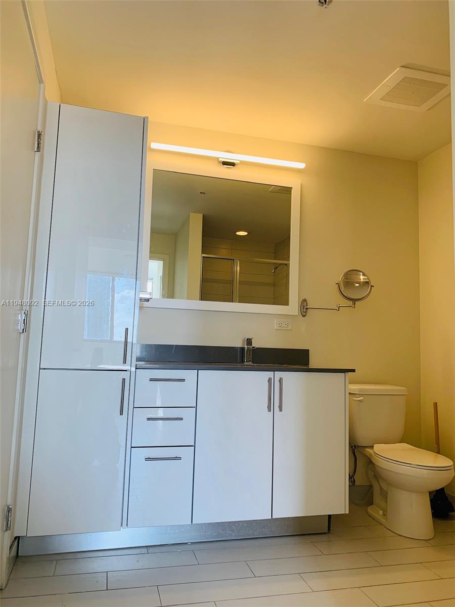 999 Southwest 1st Avenue, Unit 2310 Miami, FL 33130 - Photo 16 of 17 a bathroom with a sink and a mirror