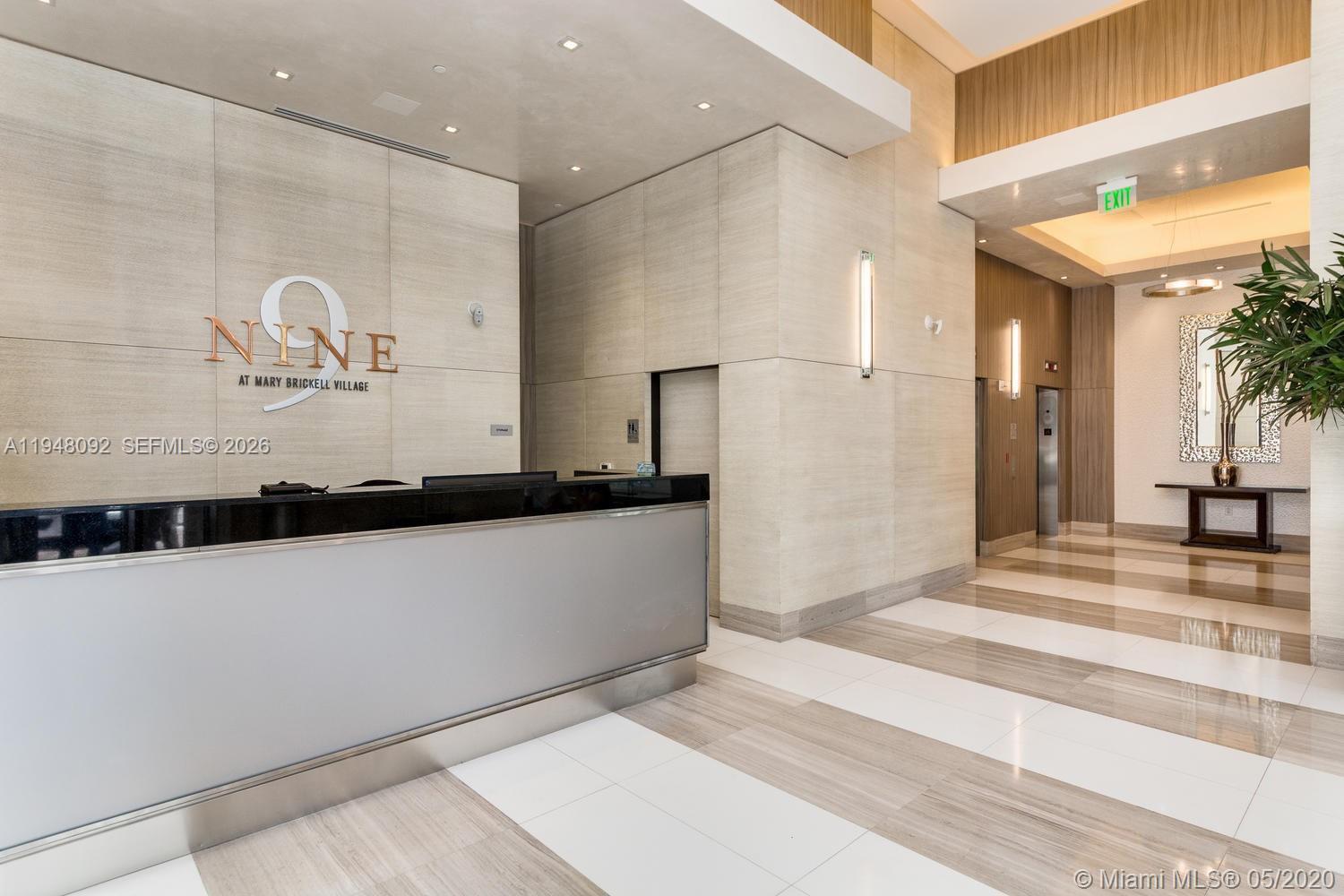 999 Southwest 1st Avenue, Unit 2310 Miami, FL 33130 - Photo 4 of 17 a view of a hallway with a window and wooden floor