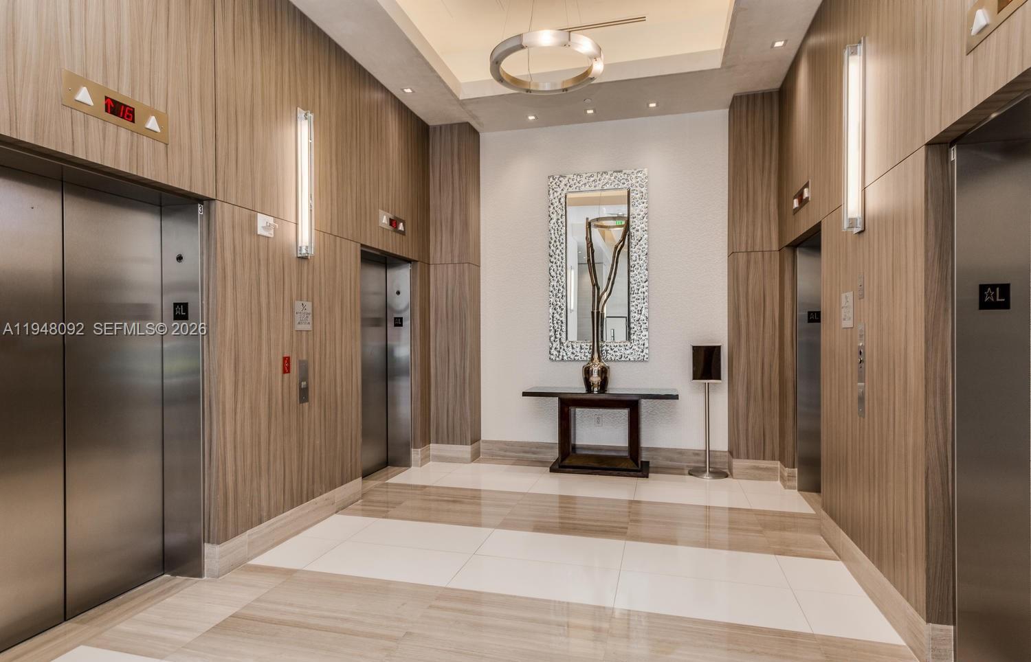 999 Southwest 1st Avenue, Unit 2310 Miami, FL 33130 - Photo 5 of 17 a view of a bathroom with sink mirror and shower