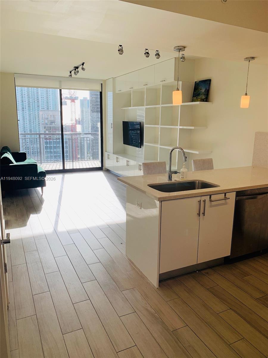 999 Southwest 1st Avenue, Unit 2310 Miami, FL 33130 - Photo 9 of 17 a kitchen with a sink and cabinets