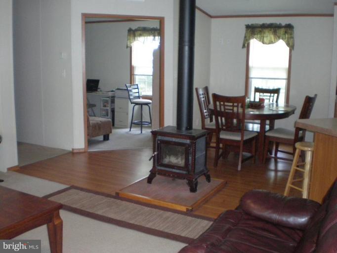 4744 Poplar Neck Road Preston, MD 21655 - Photo 11 of 11 a living room with furniture a dining table and a potted plant
