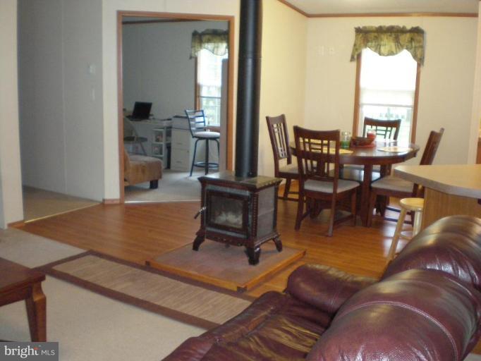 4744 Poplar Neck Road Preston, MD 21655 - Photo 4 of 11 a living room with furniture a large window and a dining table