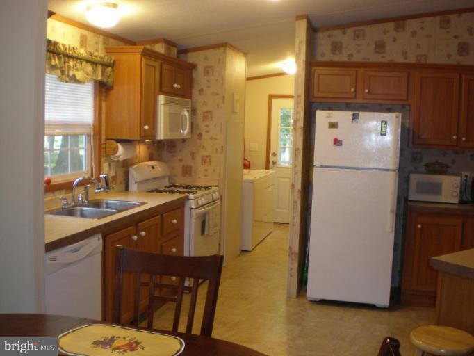 4744 Poplar Neck Road Preston, MD 21655 - Photo 8 of 11 a kitchen with a refrigerator sink and stove