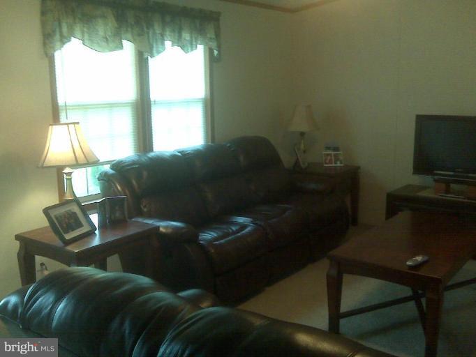 4744 Poplar Neck Road Preston, MD 21655 - Photo 10 of 11 a living room with furniture and a fireplace