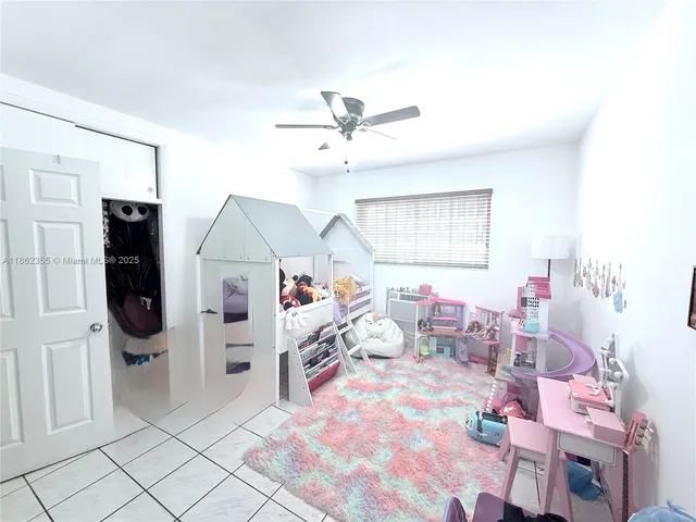 a bedroom with furniture and a fan