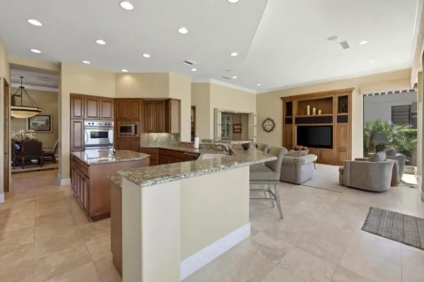 a kitchen with stainless steel appliances granite countertop a sink and a large window