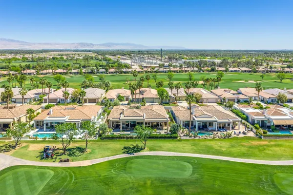 a bathroom with a granite countertop double vanity sink a mirror and a shower