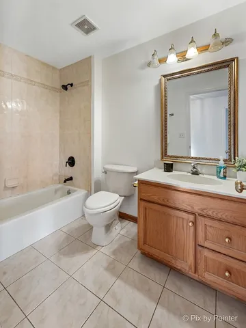 a bathroom with a granite countertop sink a toilet mirror and bathtub
