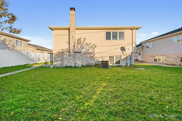 a view of a white house with a yard