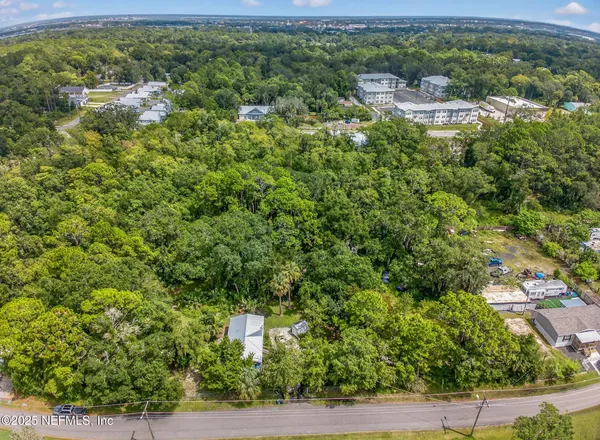 a view of a yard with potted plants