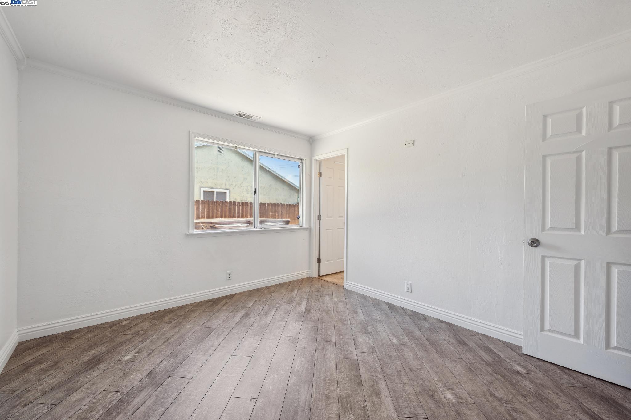148 Spinnaker Pittsburg, CA 94565 - Photo 19 of 24 an empty room with wooden floor and windows