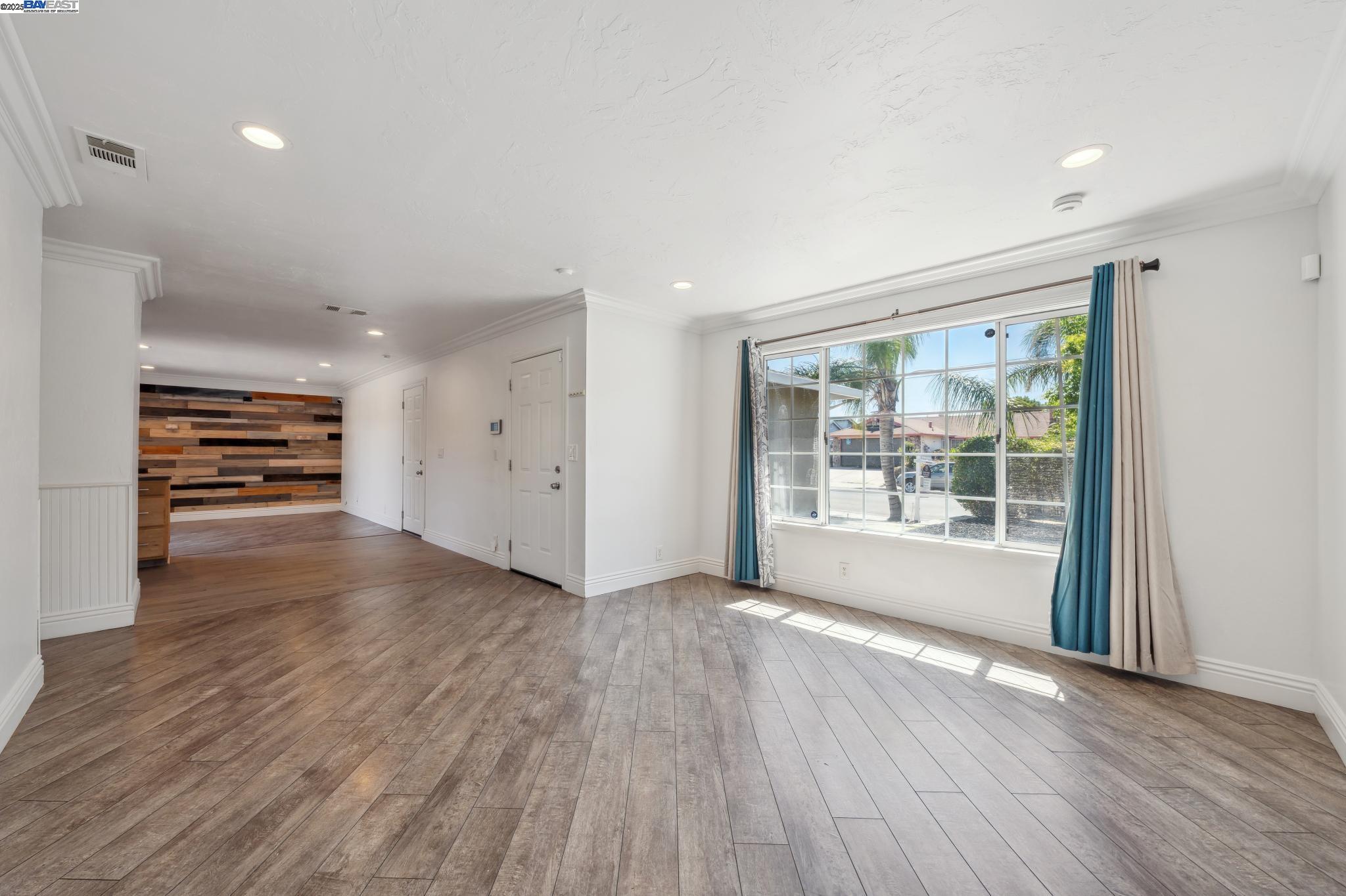 148 Spinnaker Pittsburg, CA 94565 - Photo 4 of 24 a view of empty room with wooden floor and fan