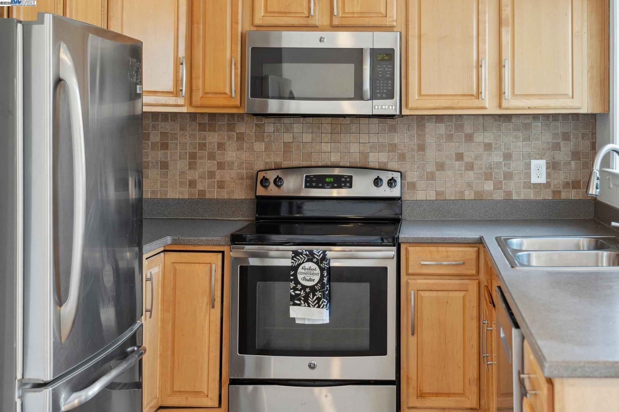 148 Spinnaker Pittsburg, CA 94565 - Photo 6 of 24 a kitchen with stainless steel appliances granite countertop a refrigerator and a stove top oven