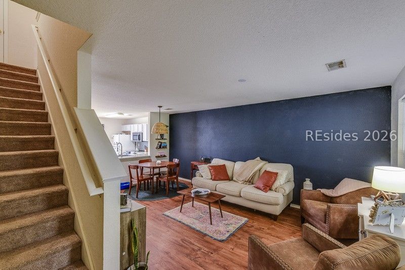 406 Park Side Way Bluffton, SC 29909 - Photo 13 of 39 Accent wall and open living space