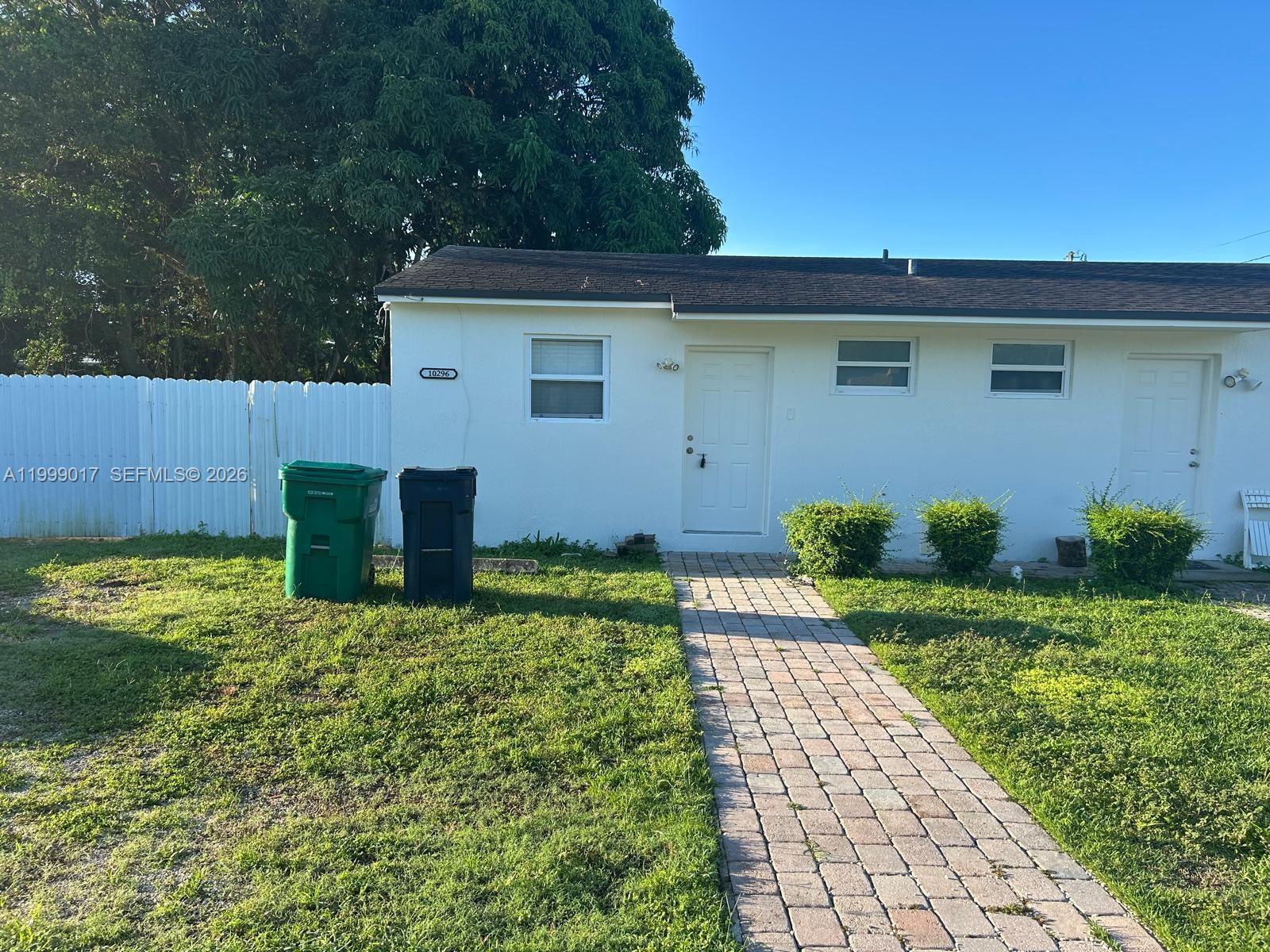 10296 Southwest 175th Street, Unit 10296 Miami, FL 33157 - Photo 8 of 9 a front view of a house with garden
