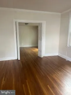 an empty room with wooden floor and closet