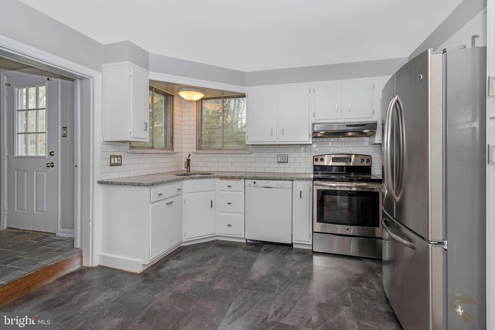 414 Devon State Road Devon, PA 19333 - Photo 11 of 31 a kitchen with a sink white cabinets and stainless steel appliances
