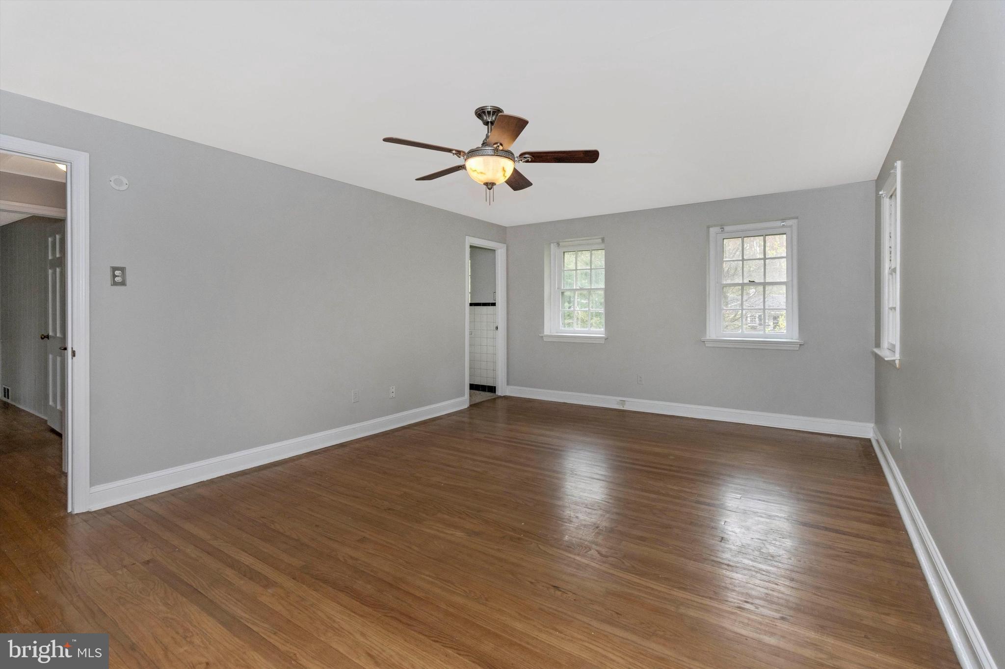 414 Devon State Road Devon, PA 19333 - Photo 20 of 31 an empty room with wooden floor ceiling fan and windows