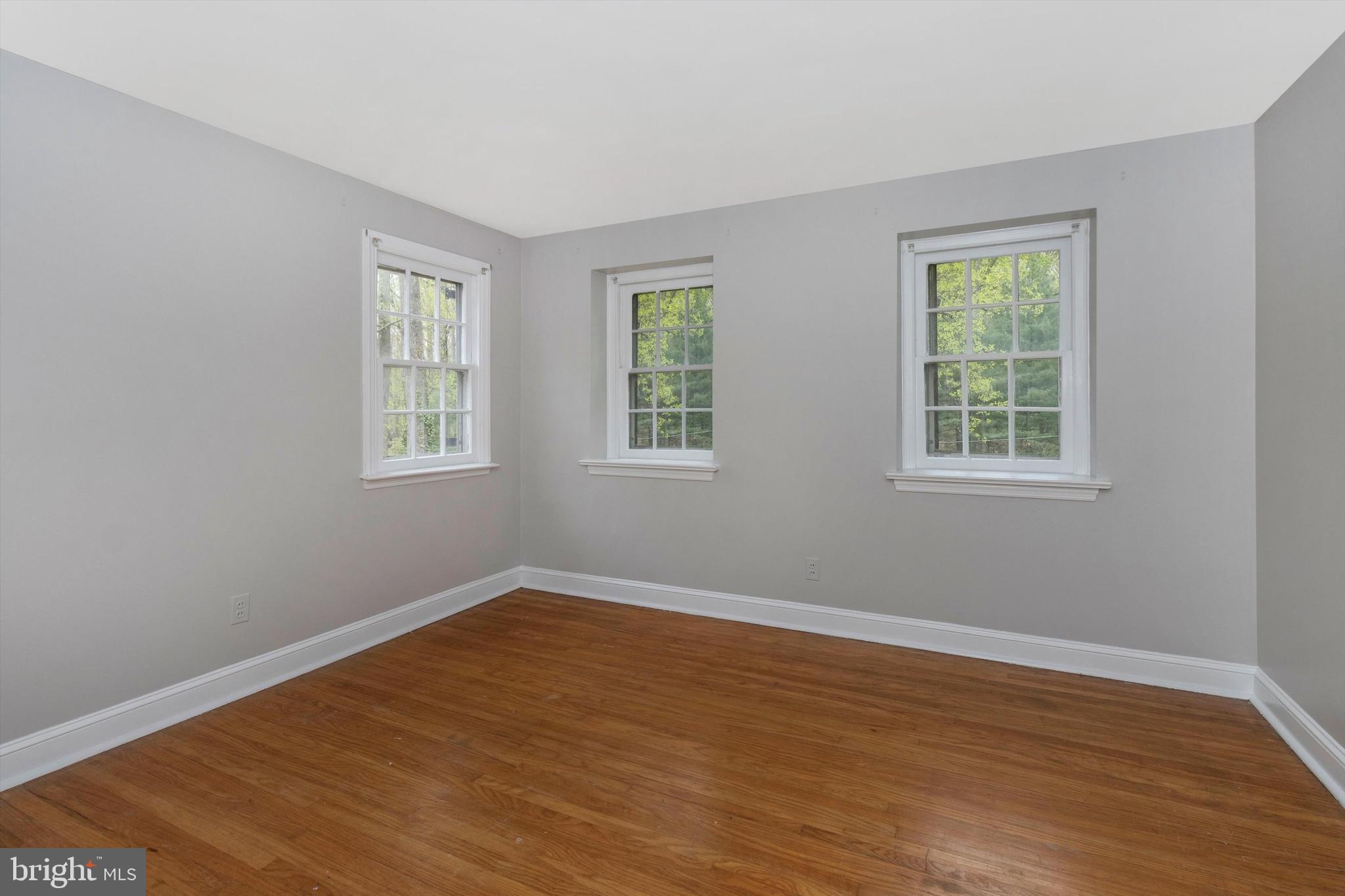 414 Devon State Road Devon, PA 19333 - Photo 22 of 31 a view of an empty room with wooden floor and a window