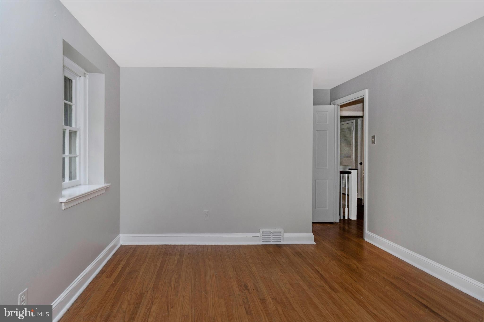 414 Devon State Road Devon, PA 19333 - Photo 23 of 31 an empty room with wooden floor and windows