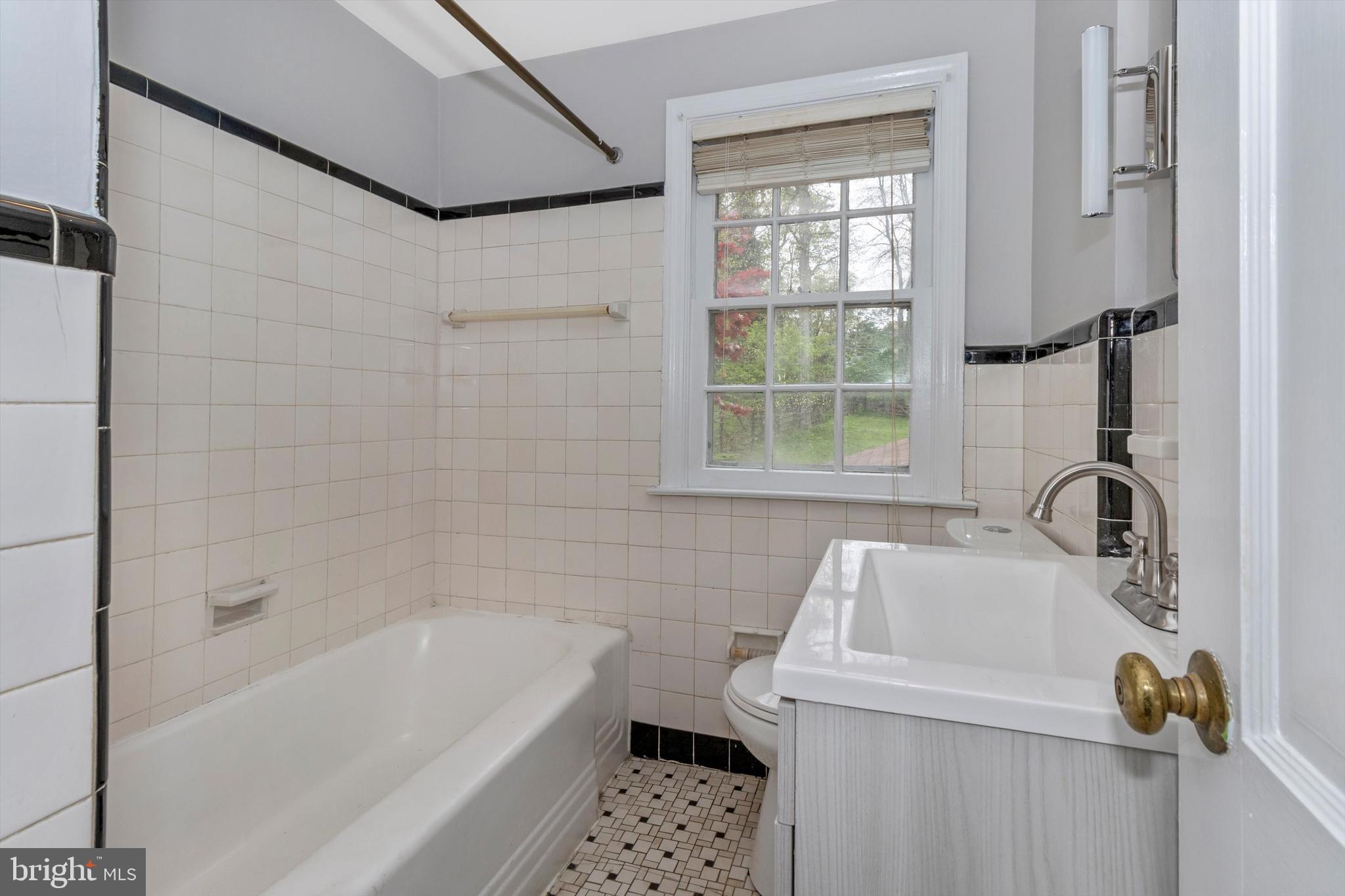 414 Devon State Road Devon, PA 19333 - Photo 27 of 31 a bathroom with a sink a bathtub and a window