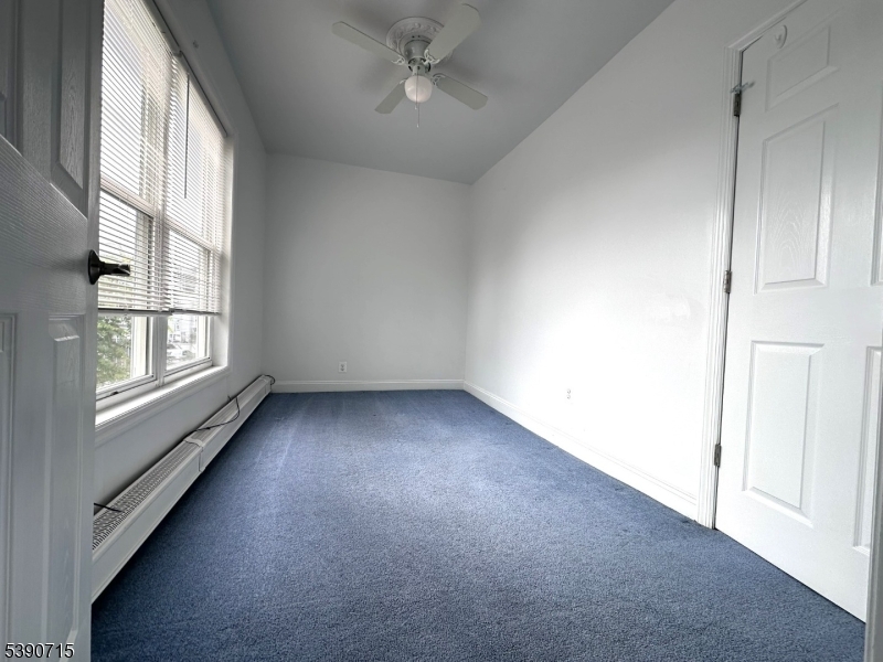 89 Getty Avenue, Unit 3 Clifton, NJ 07011 - Photo 16 of 28 an empty room with windows and ceiling fan