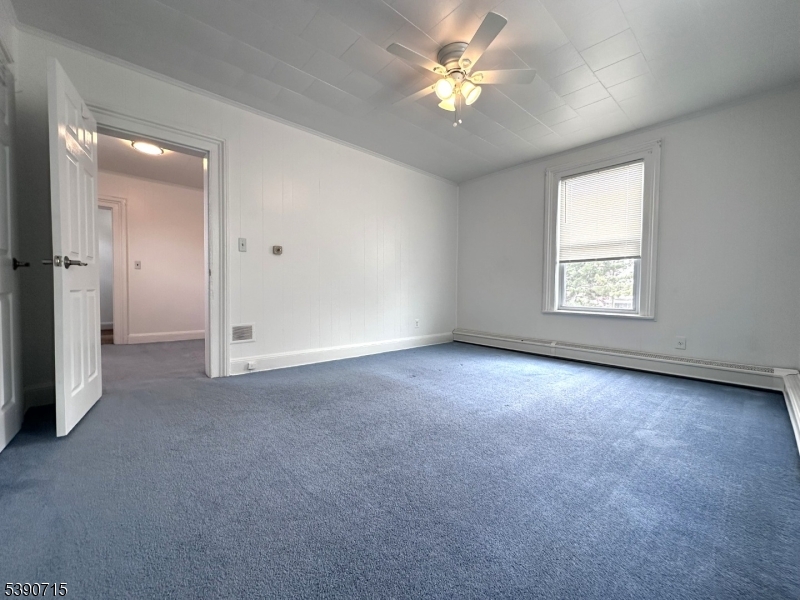 89 Getty Avenue, Unit 3 Clifton, NJ 07011 - Photo 21 of 28 an empty room with a window and a ceiling fan