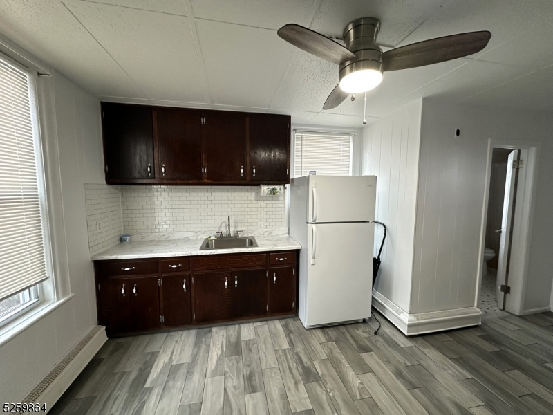 89 Getty Avenue, Unit 3 Clifton, NJ 07011 - Photo 8 of 28 a kitchen with stainless steel appliances granite countertop a refrigerator a stove a sink and a microwave