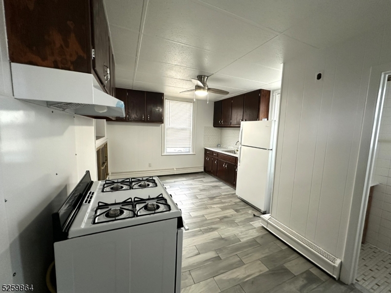 89 Getty Avenue, Unit 3 Clifton, NJ 07011 - Photo 10 of 28 a kitchen with stainless steel appliances granite countertop a refrigerator a stove and a sink