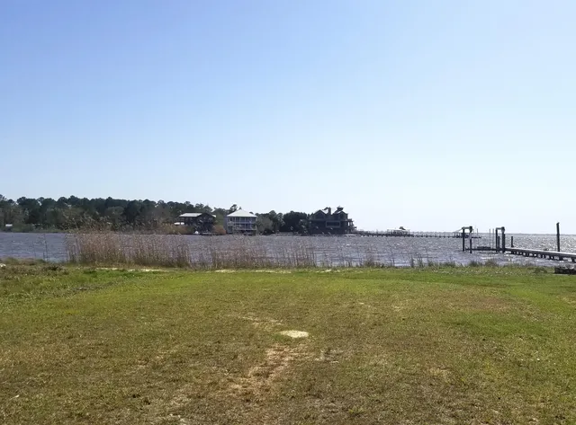 a view of a lake with houses in the back