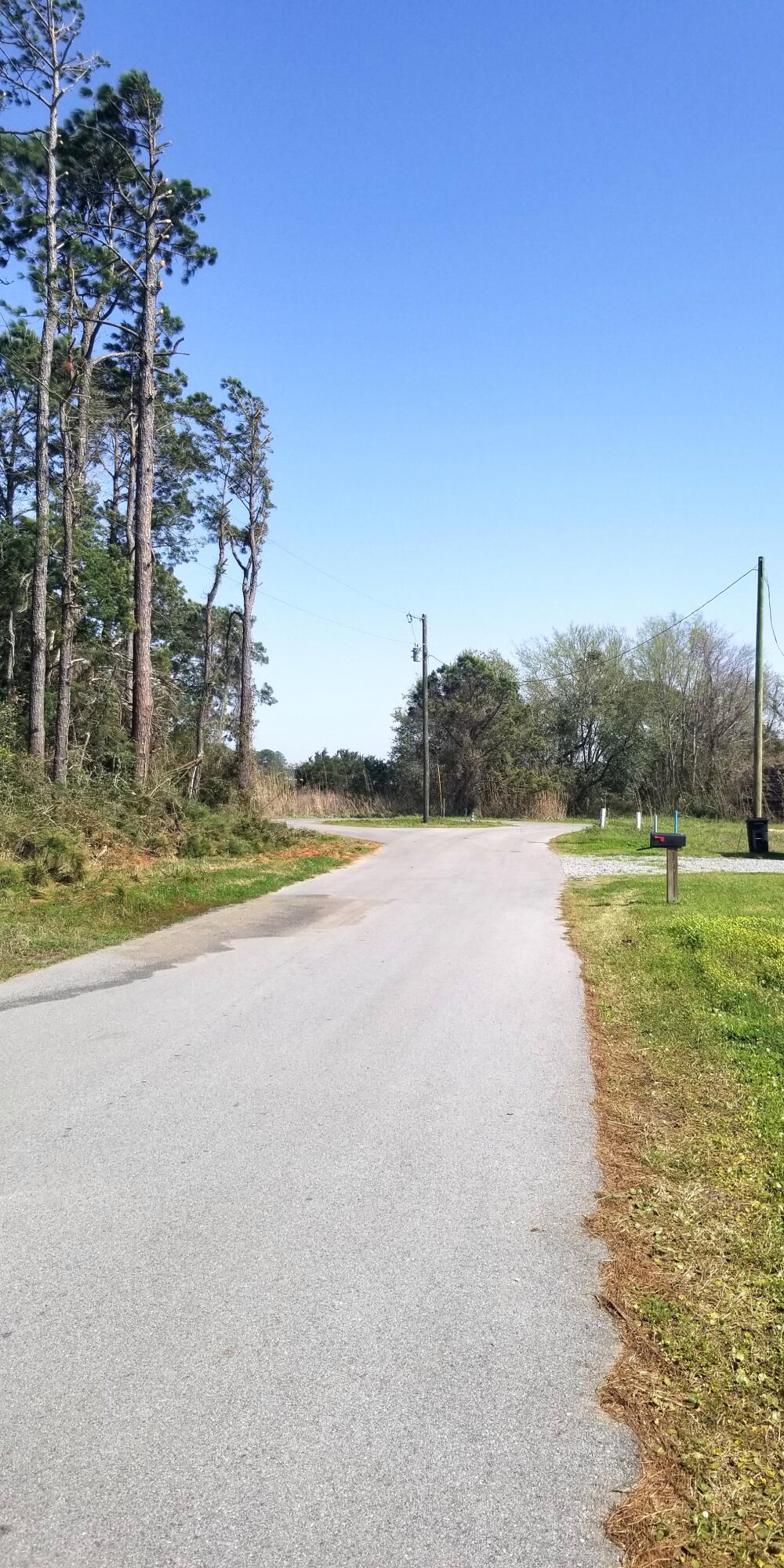 554 Beatrice Point Road Freeport, FL 32439 - Photo 24 of 24 a view of a lake with a big yard