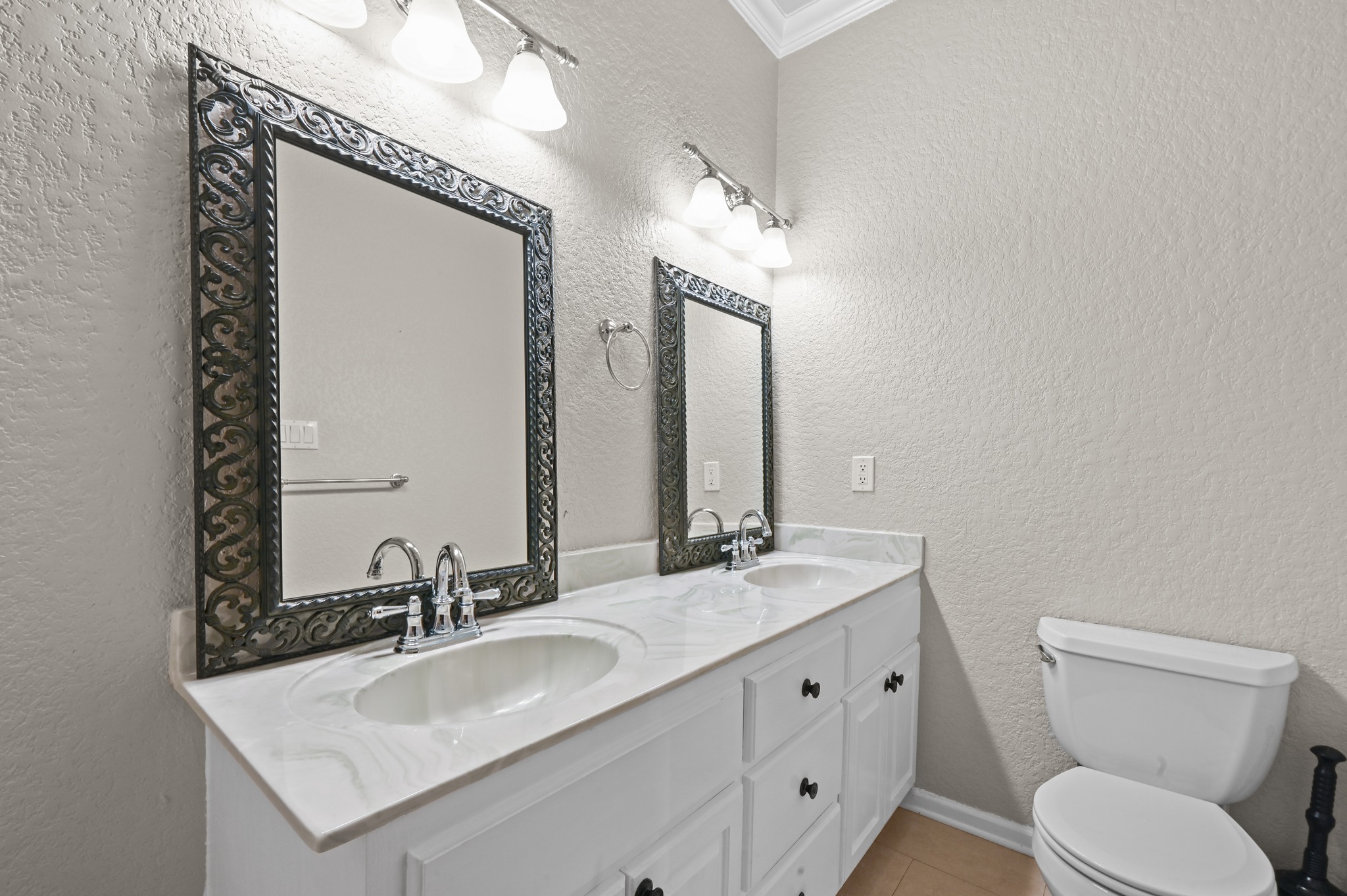 1175 Southern Way Luling, TX 78648 - Photo 33 of 40 Double vanities with sleek countertops and elegant mirrors elevate this well-appointed bathroom.
